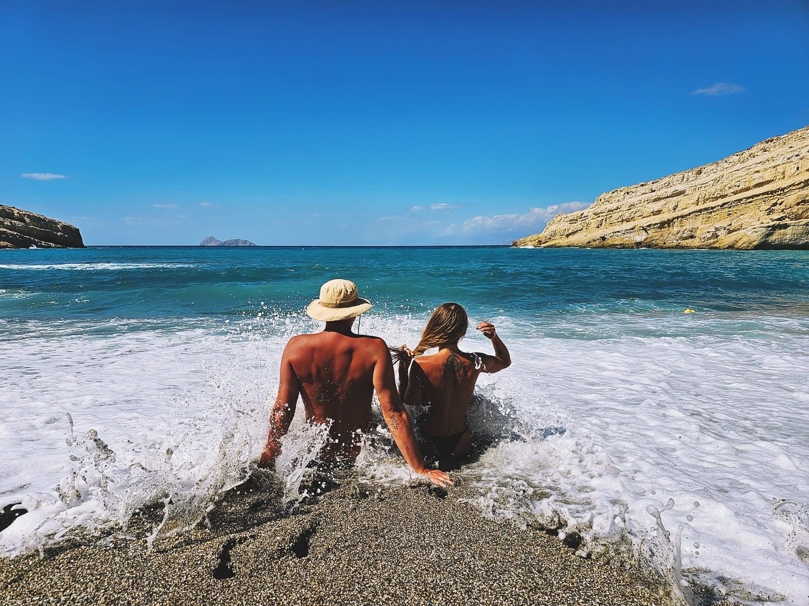 Anne-Sophie und Felix sitzen zusammen in der Brandung am Strand
